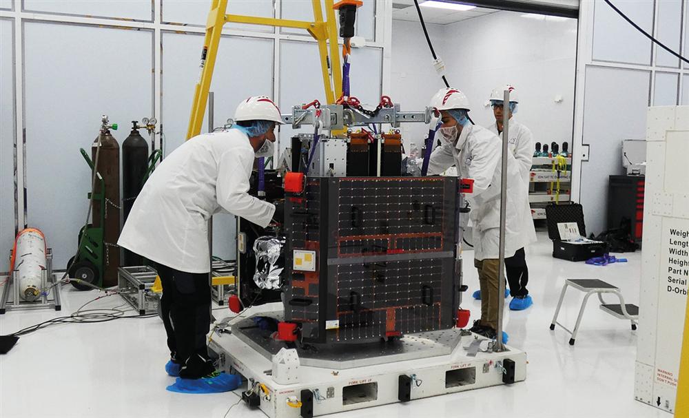 Impulso Space staff working on a satellite in the Florida cleanroom